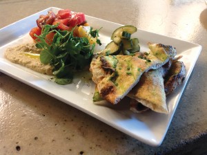 Chef Douglas Katz's tomato and eggplant salad with house-made naan and pickled cucumber salad.