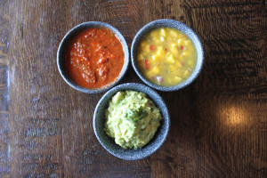 Clockwise from top left: Fire-Roasted Tomato salsa, Caribbean Mango salsa and a traditional guacamole.