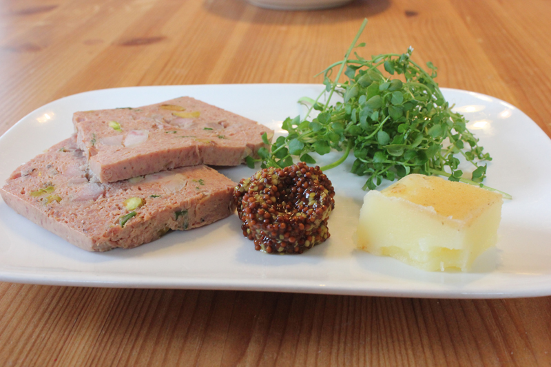 Chicken liver mousseline in a “Schmaltz spread” plate setup (a manner in which diners will be able to order from the menu), shown here to include a wild greens salad, wild whole-grain mustard and schmaltz.