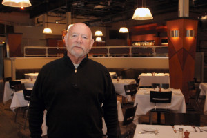 Brad Friedlander, one of four partners in Red Restaurant Group, stands in the dining room at Moxie the Restaurant in Beachwood, which he says has occasionally featured Asian dishes on its menu over the years.