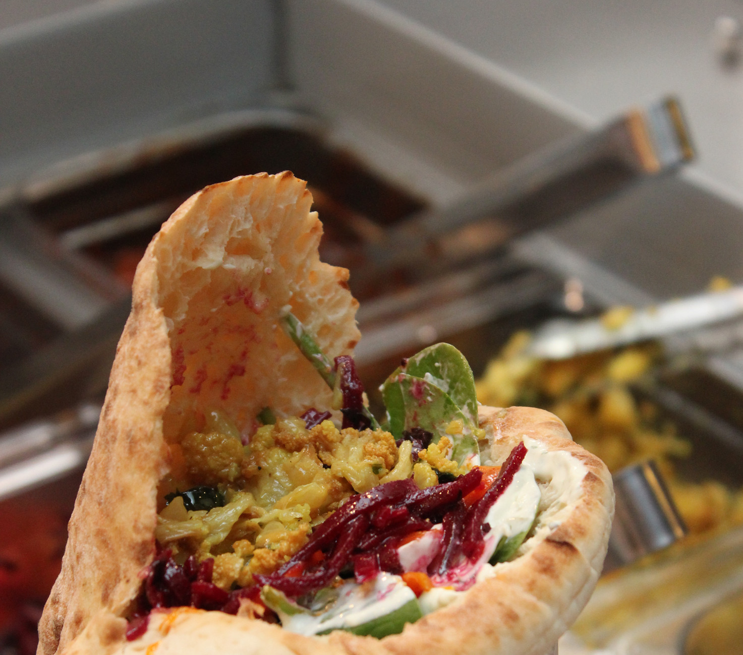 A falafel pita is prepared at Seth Bromberg’s Raving Med in downtown Cleveland’s Playhouse Square district.