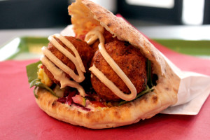 A falafel pita that features spinach, Israeli salad, pickled beets, pickled cauliflower, pickled carrots, tzatziki and tahini, also from Raving Med. 