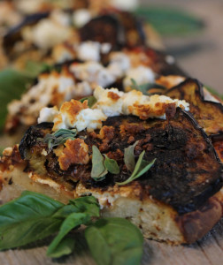 An eggplant and feta wood-fired pizza with fresh mint and tomato sauce. 