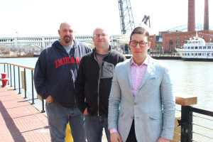 Front to back, Collision Bend Brewing Co. director of service Julian Bruell, Collision Bend Brewing Co. executive chef Andy Dombrowski and Collision Bend Brewing Co. brewmaster Luke Purcell stand on Collision Bend’s main patio. The turn in the Cuyahoga River from which the brewpub gets its name is a little farther downstream, not the turn behind the trio.