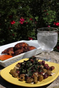 Chef Douglas Katz’s Swiss chard with onions, served on a bed of olives, and his Harissa roasted chicken, served with a purée made during the final step of the recipe (see below).