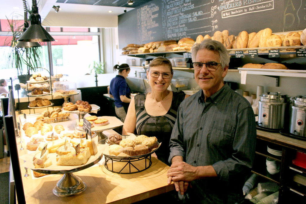Tatyana Rehn and John Emerman, co-owners of The Stone Oven, stand behind the pastry counter at the Cleveland Heights location.