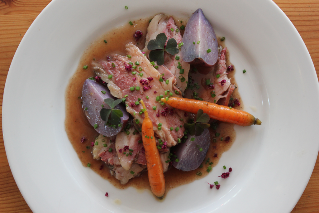 Umansky suggests using odd numbers when plating dishes, as he did with three slices of meat and a total of five colorful carrots and potatoes. 